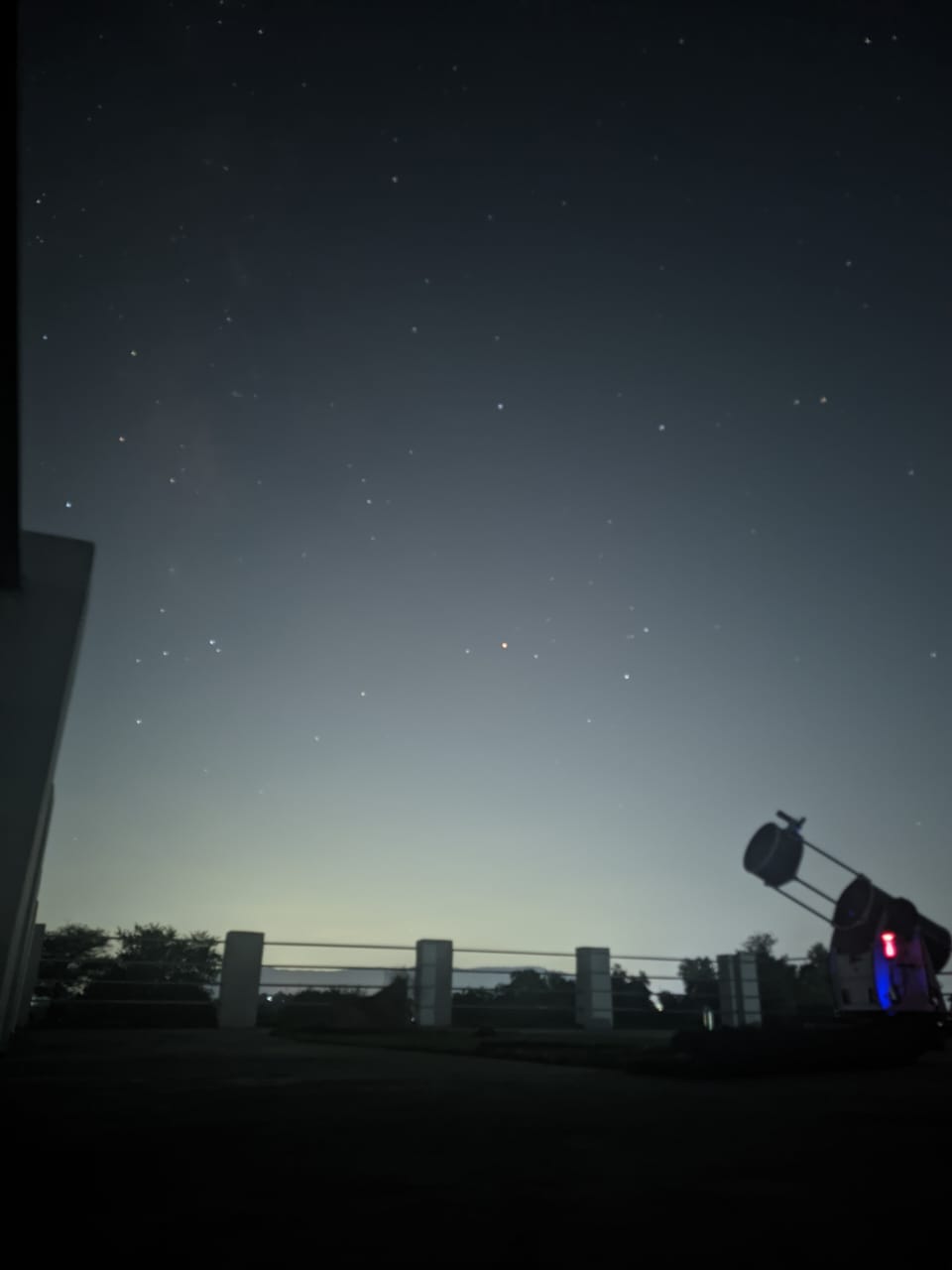 An observer at the eyepiece beneath a brilliant comet